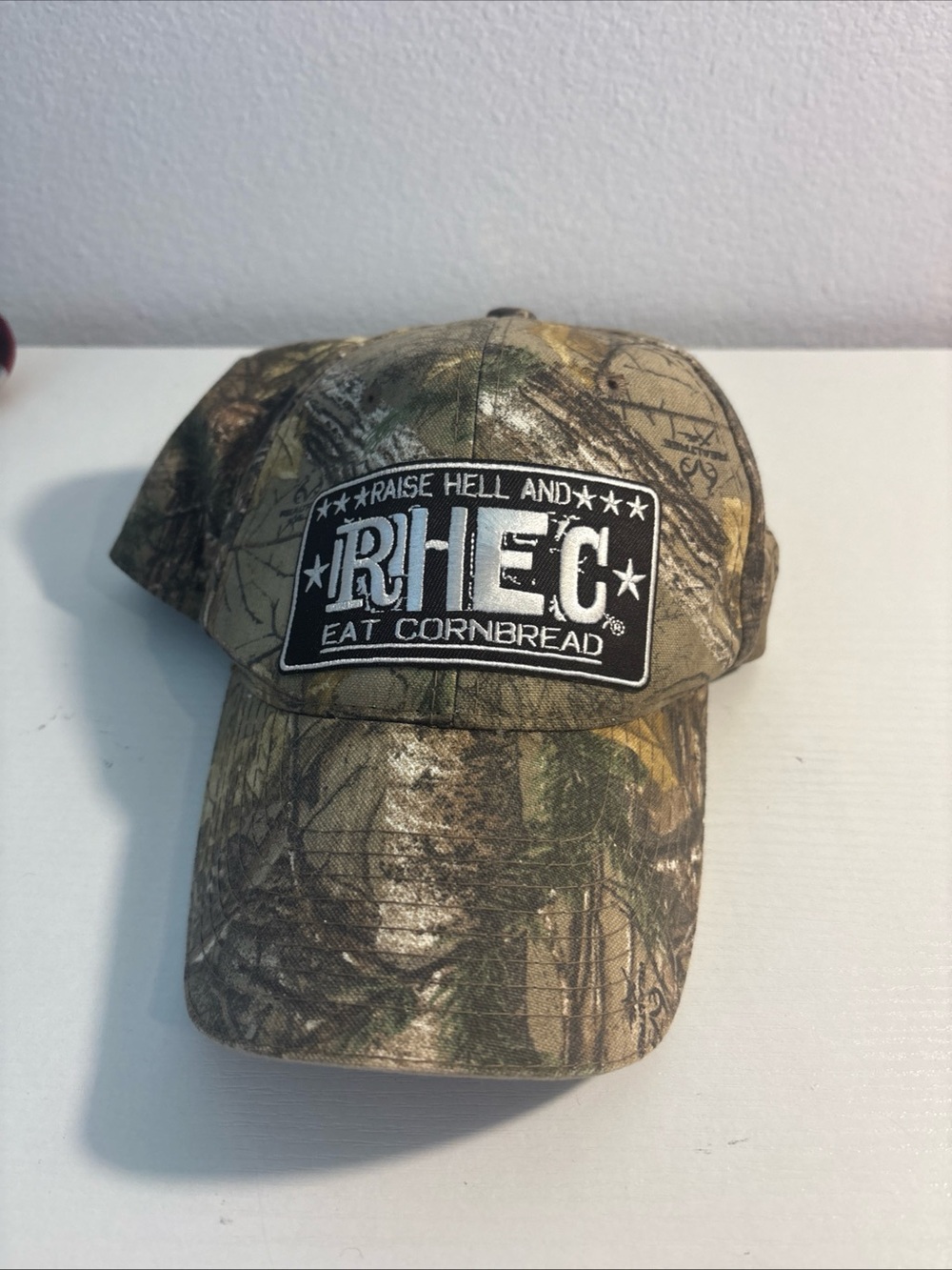RHEC Hat Unisex OSFM Camo “Raise Hell Eat Cornbread” Real Tree Cap